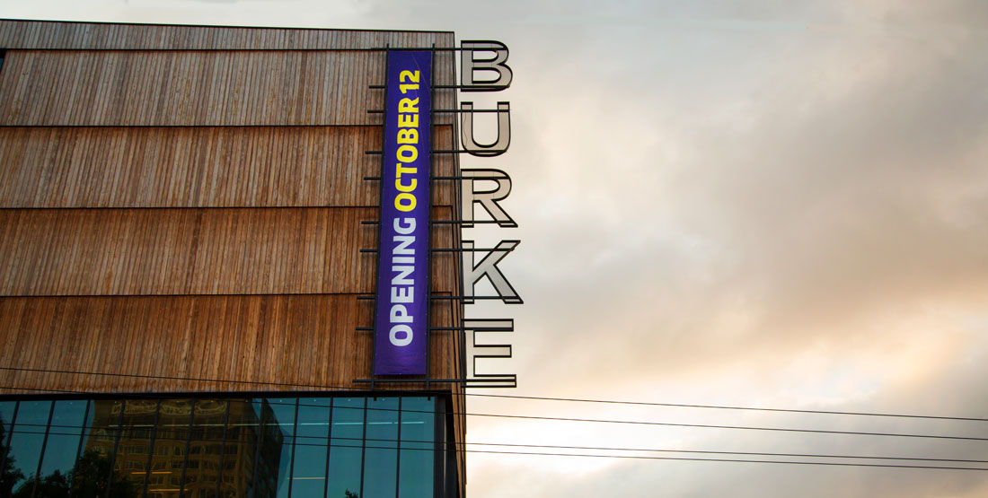 burke banner reading "opening October 12" on the side of the new building