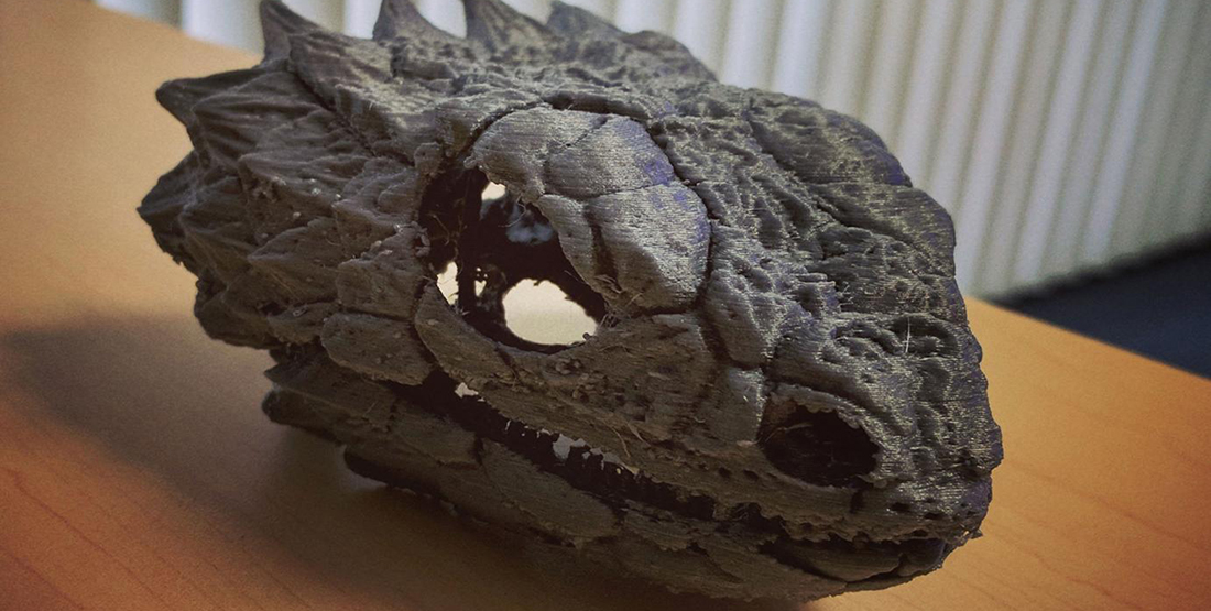 A 3-D printed skull of a giant lizard sitting on a table