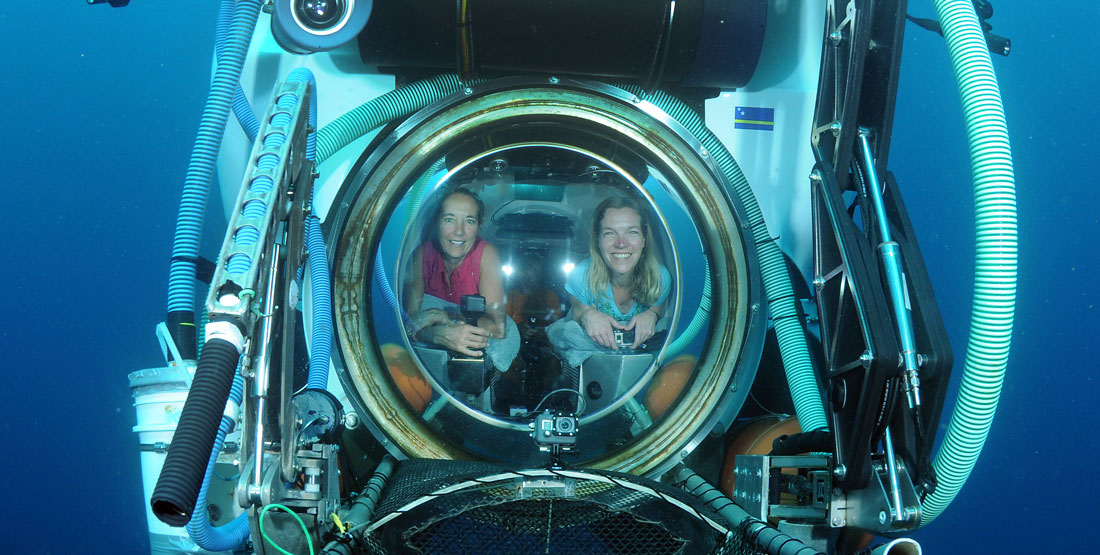 two women inside of a submarine port hole