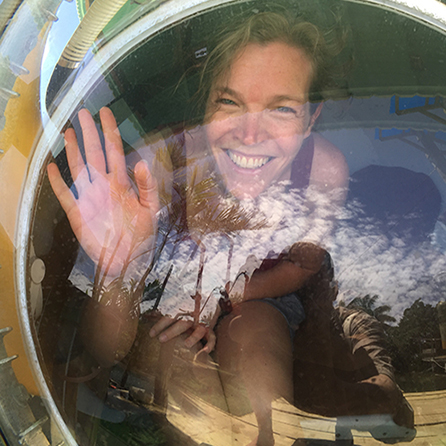 a woman waves from the window of the submersible while it's still above water