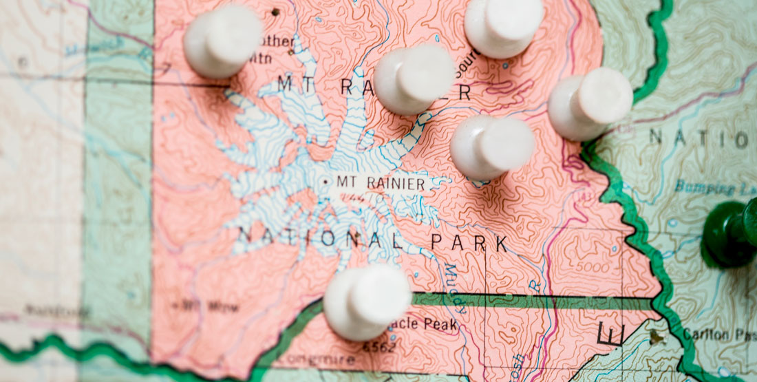 close up of push pins in a map of Washington state -- showing only Mt. Rainier region