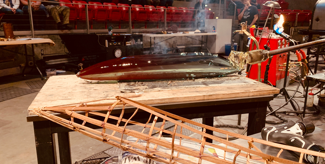 A glass canoe being blown at the Museum of Glass hot shop