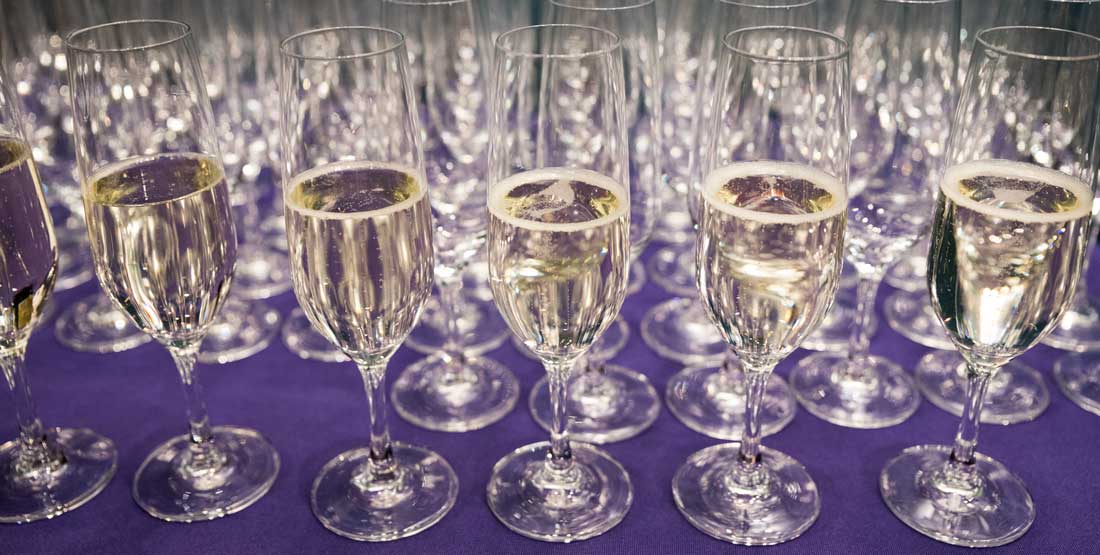 champagne  glasses on a purple tablecloth