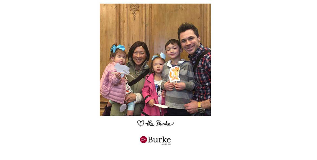 a family smiles for the camera in the Burke photobooth