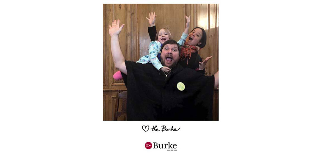 a family smiles for the camera in the Burke photobooth