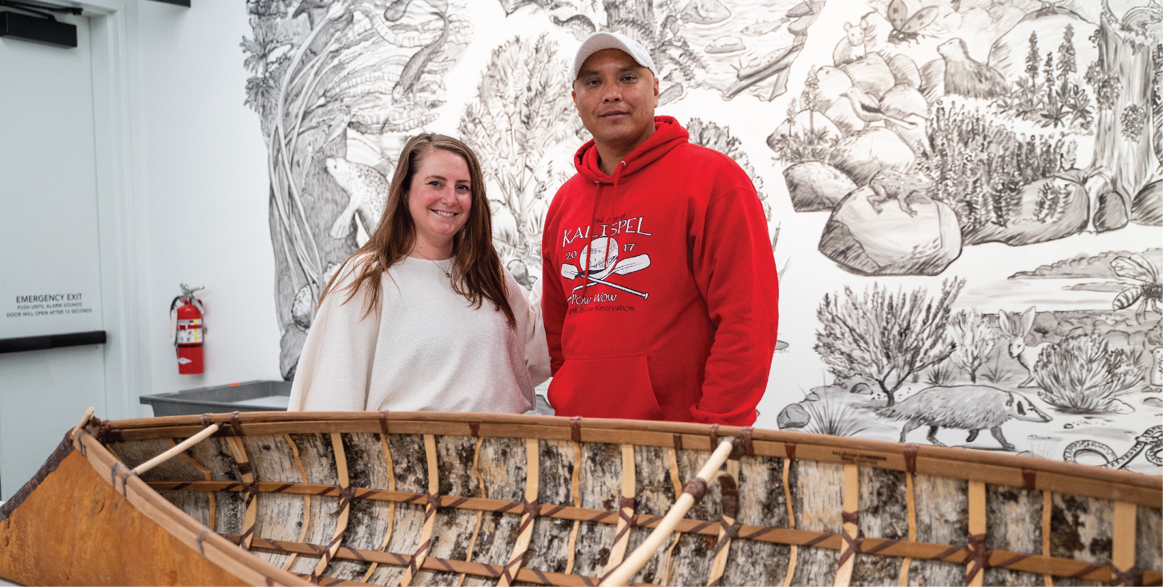 Shawn Brigman and Assistant Director for the Bill Holm Center Bridget Johnson pose together next to the bark sturgeon-nose canoe.