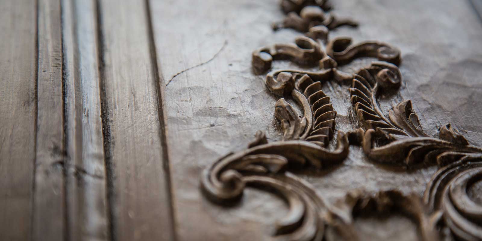 A close up of the intricate details in the wood showing toolmarks from the sculpter