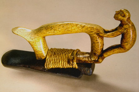 A carving tool with a figure decorated on the handle