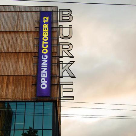 new burke banner reading "opening October 12" on the side of the new building