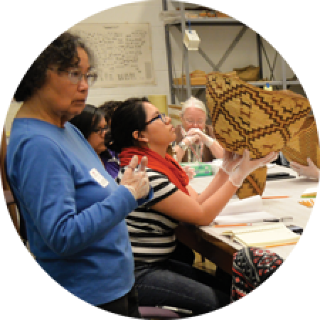a woman leads a group workshop on basketry