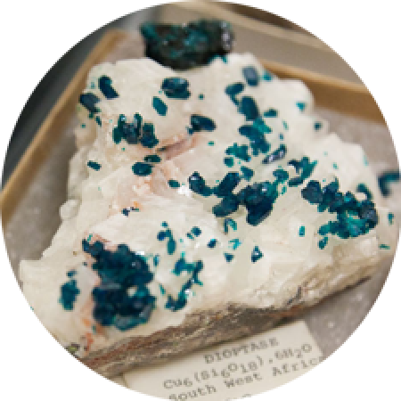 close up of a mineral specimen that is white and teal in color