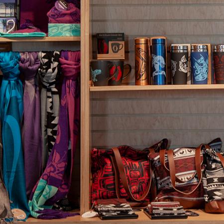 Scarves, mugs and bags on a shelf