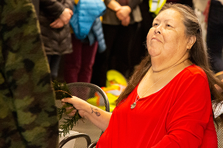 A Tribal Elder brushing cedar during the blessing