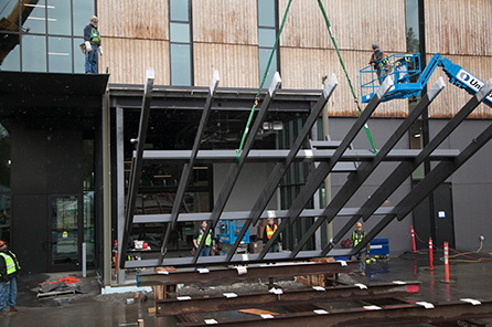 The pivoting window wall being installed by crane