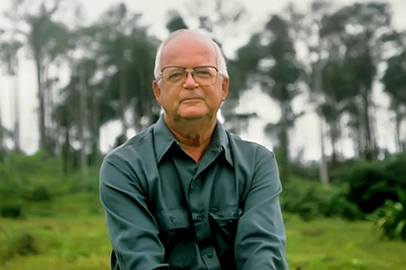 An older man sits outside