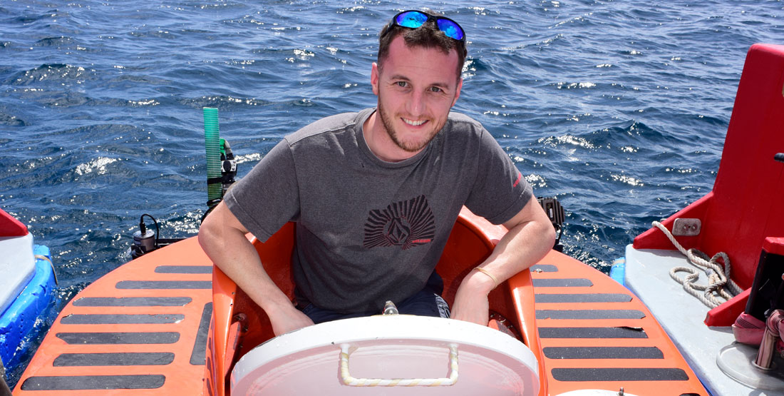 a man stands in the porthole of a submarine