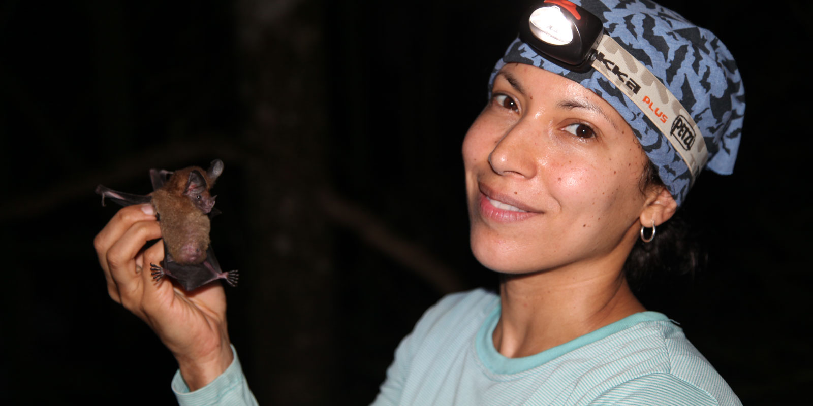 A researcher holds a bat