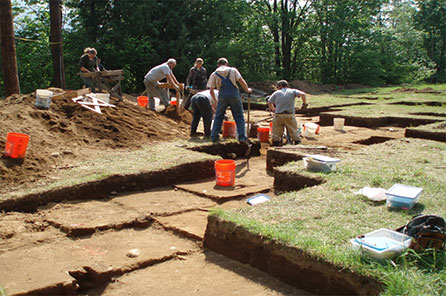 a team of archaeologists work at a dig site