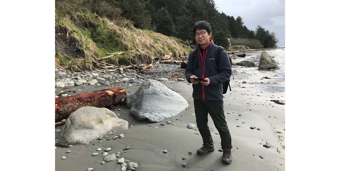 Dr. Takase stands on the beach at the Ozette site in Winter 2018.