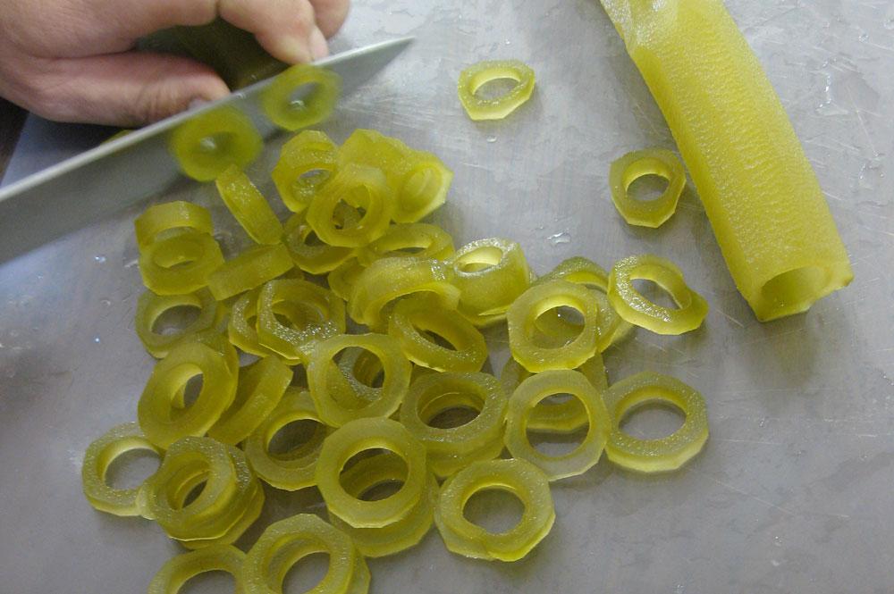 kelp pickles being cut with a knife