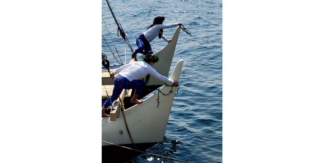 honoring the visiting hawaiian voyaging canoe with lei