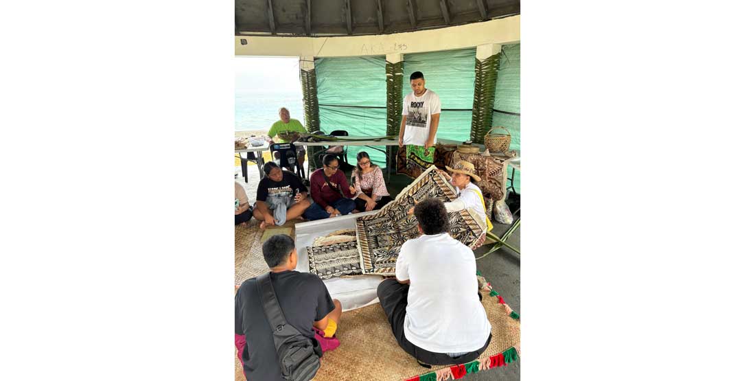 Reggie Fitiao shares work with a group of adults