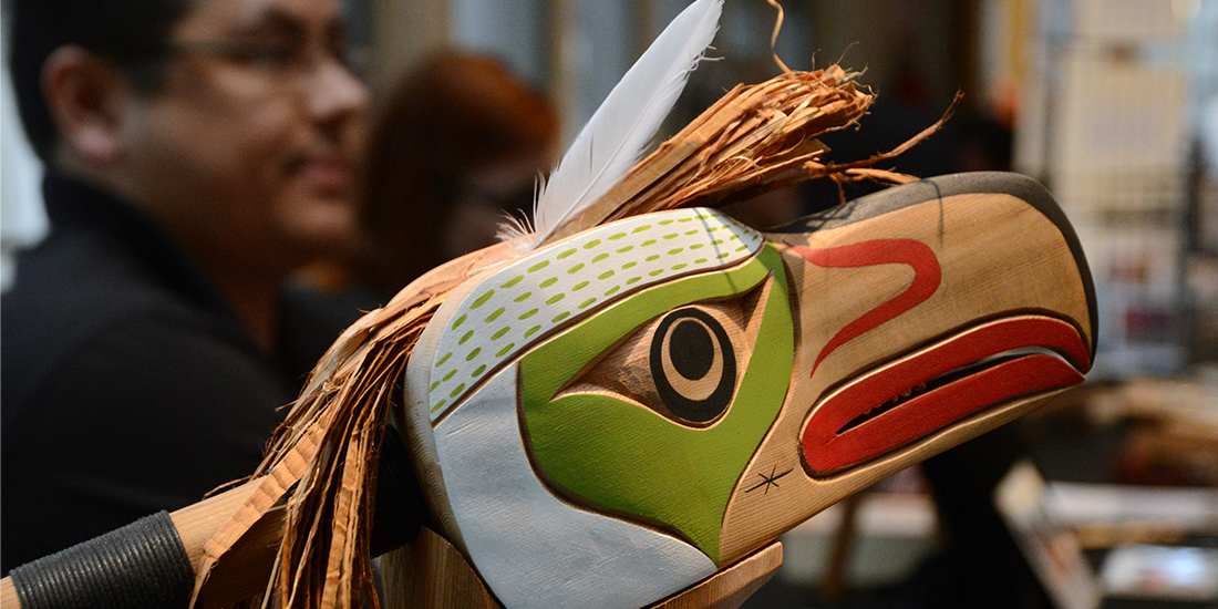 A carved and painted eagle rattle