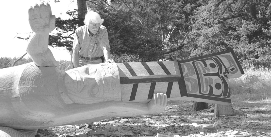 a black and white photograph of bill holm carving