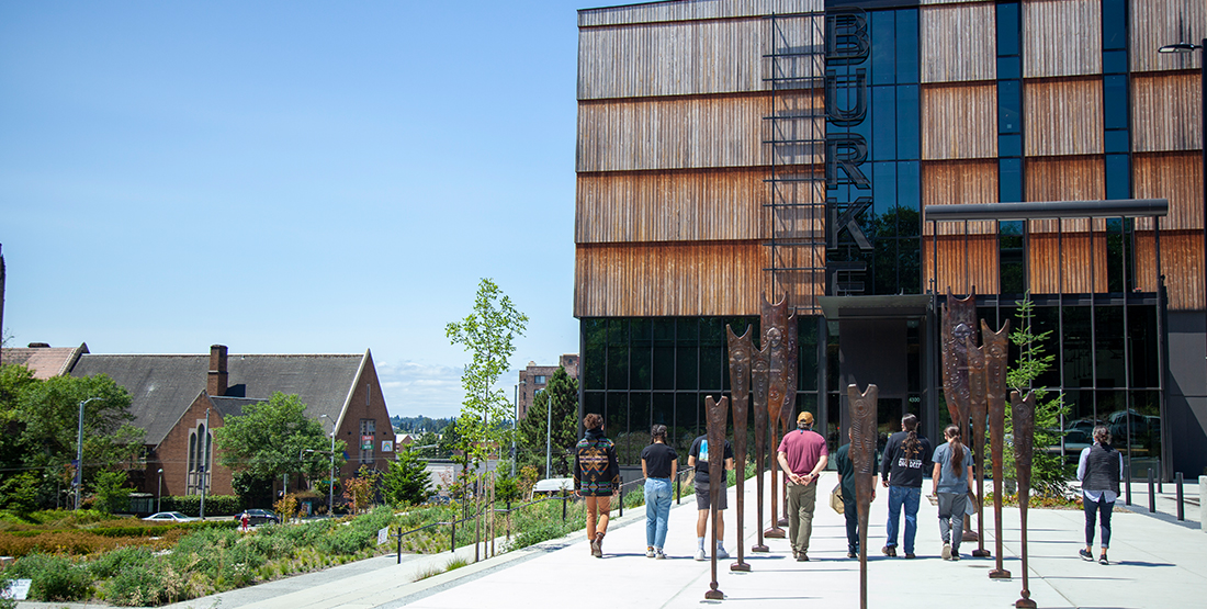 Bronze paddles stand in front of the entrance to the burke museum