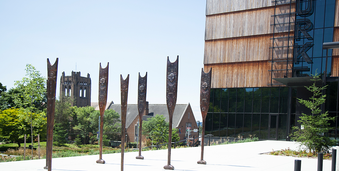 Bronze canoe paddles stand in front of the entrance to the Burke Museum