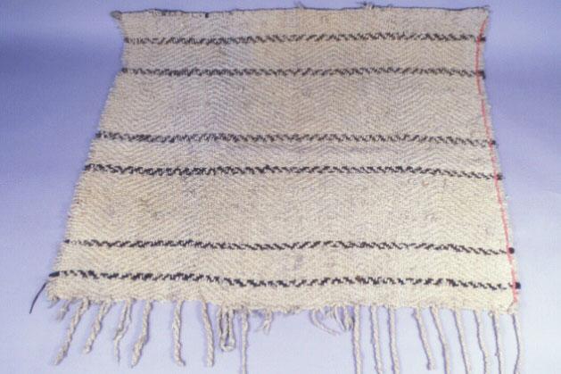 A white robe with fringe and black stipes
