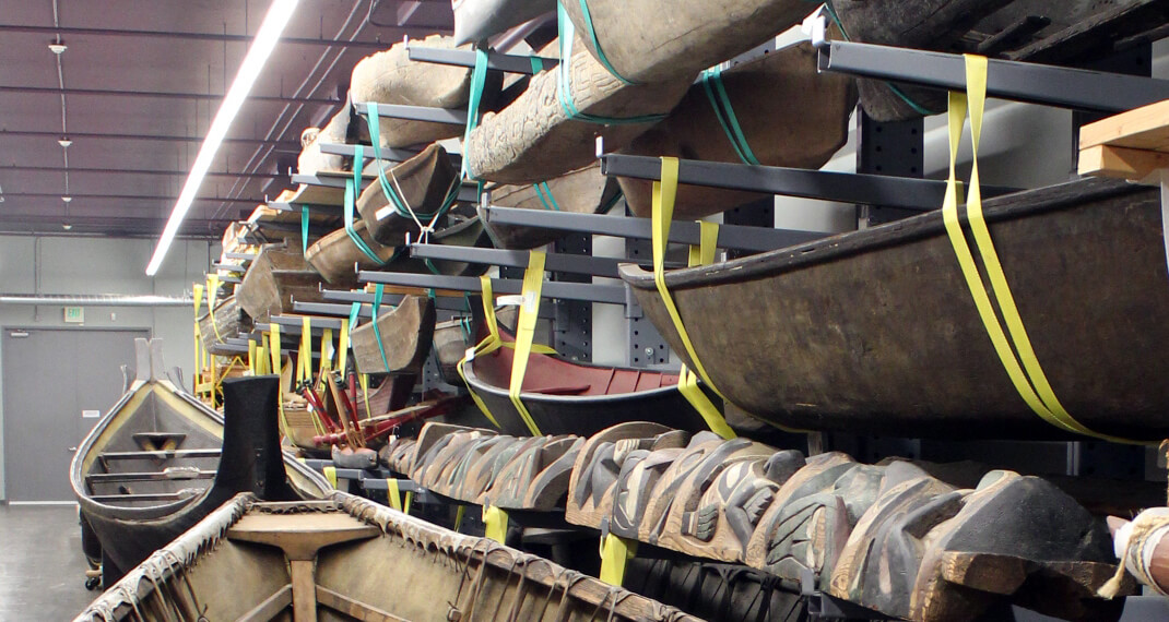 boats secured to the wall and stacked high in a collection space