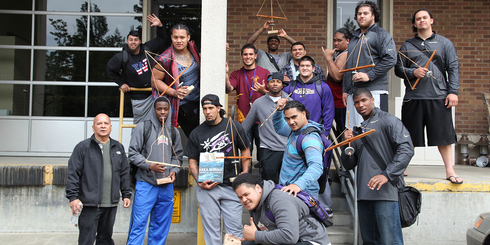 a group of young men hold the pump drills they just made