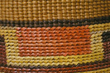 a woven basket with stripes running across it