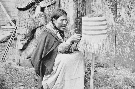 a woman sits and weaves a basket on a post