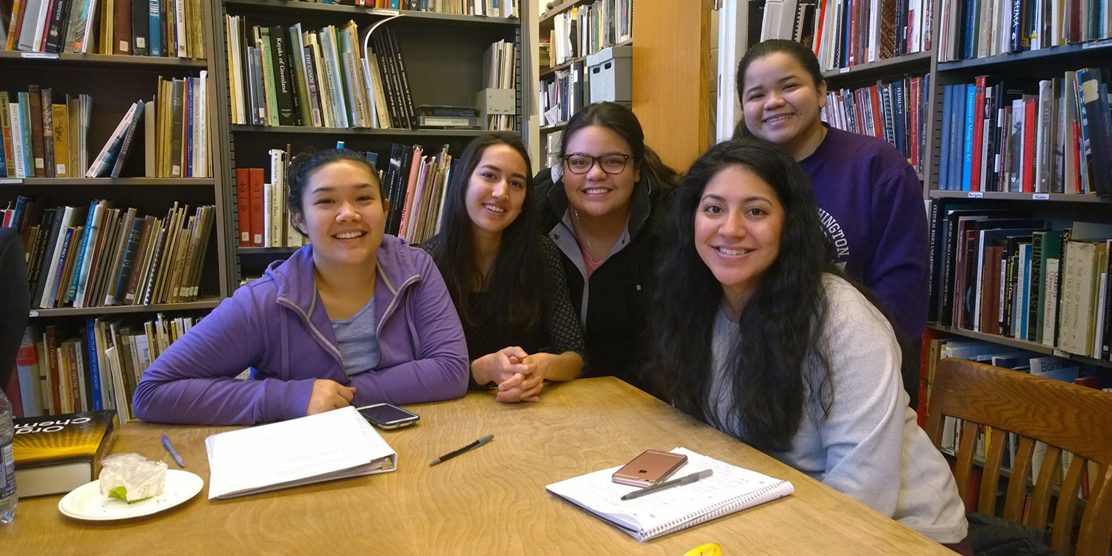 a group of young women sit at a table in the Burke collections