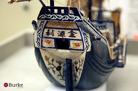 A close up view of the intricate decoration on the stern of a model boat