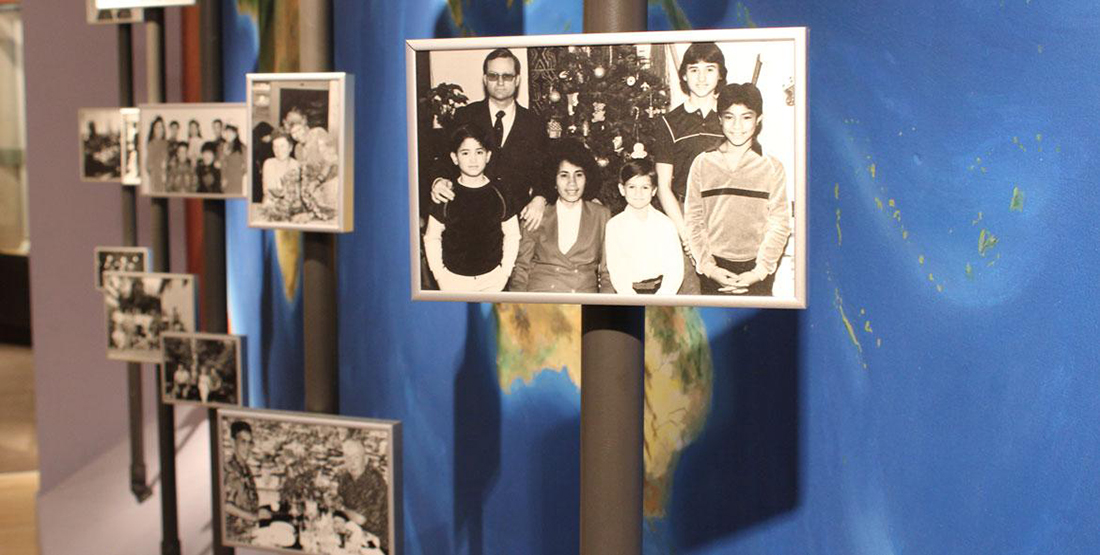 A close up view of family photographs within a museum display