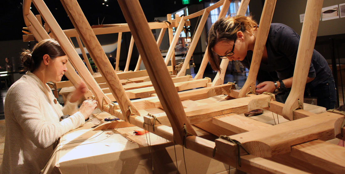 Two women work on the Angyaaq boat