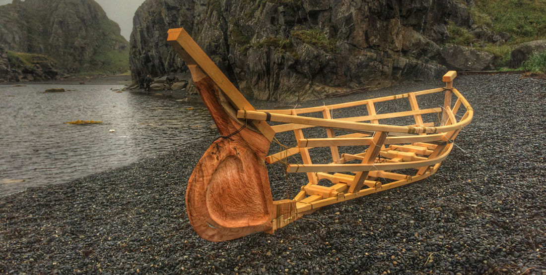 The finished Angyaaq boat frame on the beach next to water