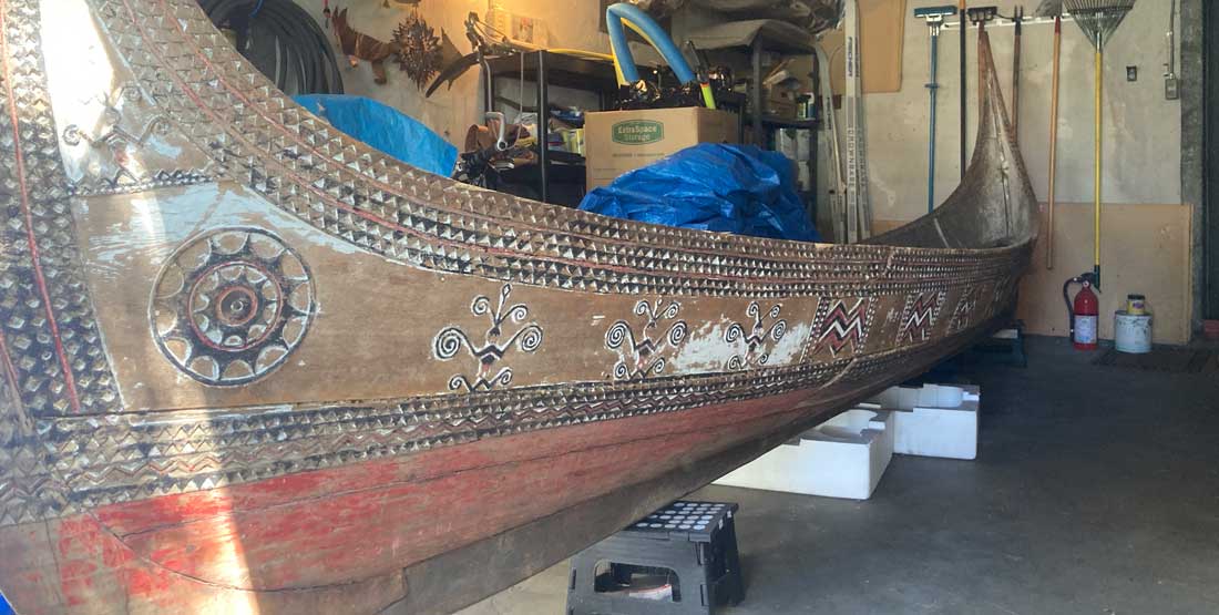 a tatala canoe in storage in a garage