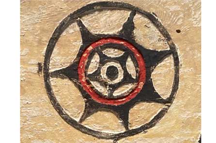 a black circle with smaller circles inside connected by spokes of a star shape