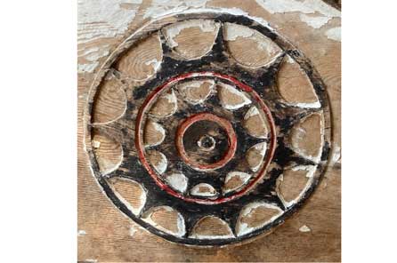 a black circle with smaller circles inside connected by several spokes of a star shape