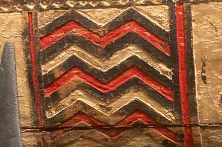 red and black zig zag pattern carved into the side of the tatala