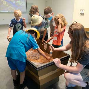 kids at camp participate in a dig pit activity