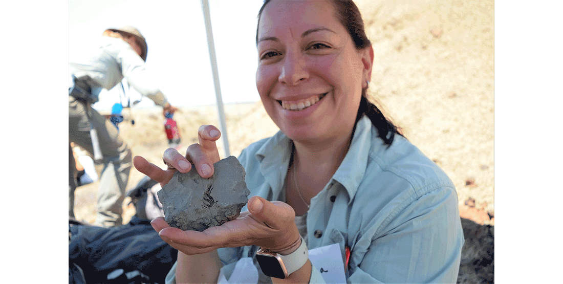 A participant shares a plant fossil specimen from the project site.