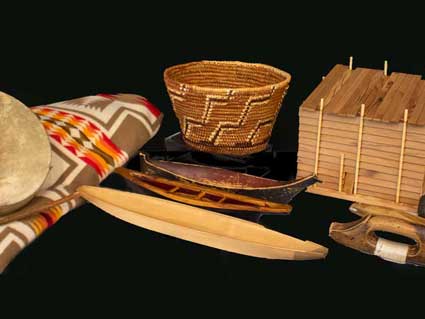 canoe models, a blanket, a drum, a cedar coil basket