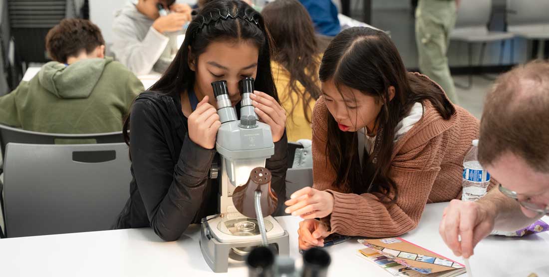 voices in science participants use a microscope