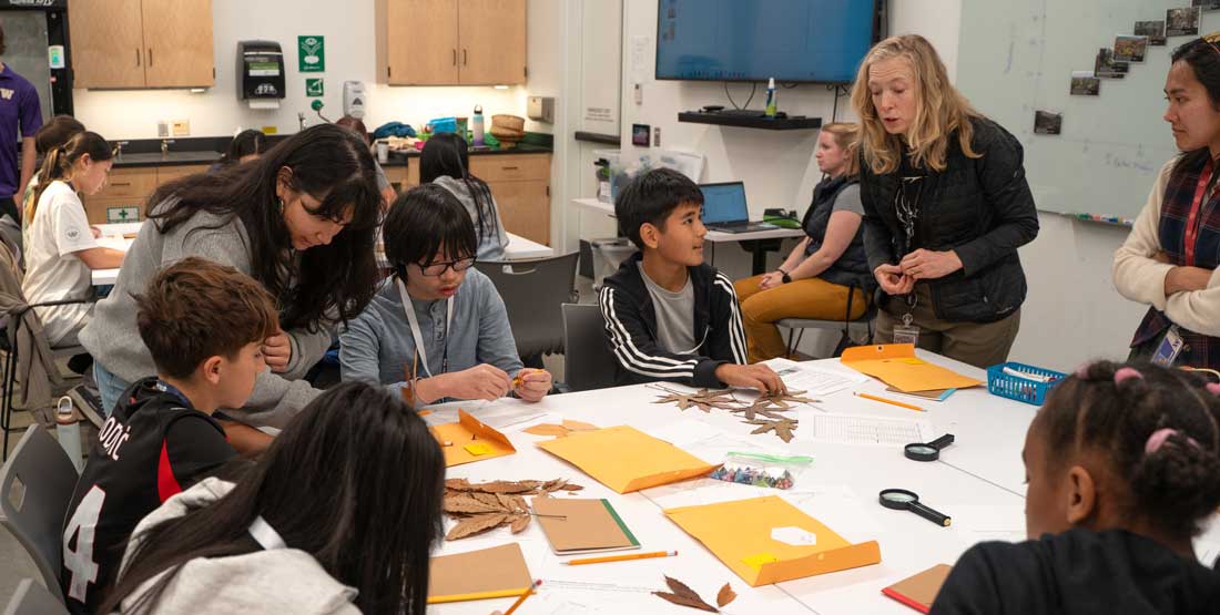 voices in science participants work around a table