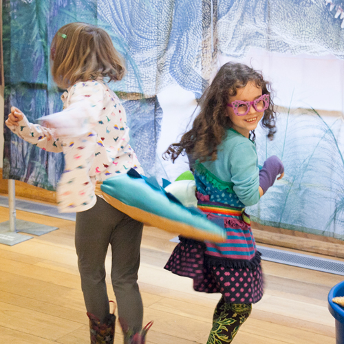 kids spin wearing dino tails